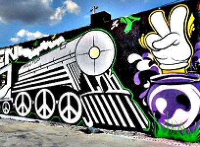 Mural with a train and peace signs for the wheels and a hand with two fingers up in a peace sign