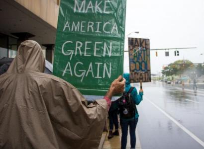 Person hold Make American Green Again sign