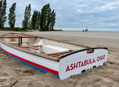 Boat on sandy beach with Ashtabula Ohio on it