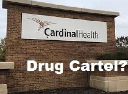 Brick sign outside with words Cardinal Health and words superimposed over picture in white below saying Drug Cartel?