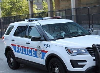 Large white SUV with Police in letters on the side and lights on top