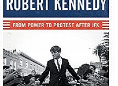 Book cover that's red white and blue with a black and white photo of Robert Kennedy as a young man in a suit walking through a crowd on both sides of a street and the book title at top and the words From Power to Protest After JFK
