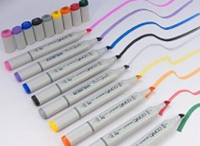 Lots of white handled thick marker pens all in a row making squiggly lines of different colors