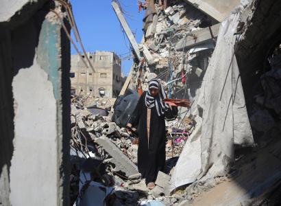 Woman standing amid rubble