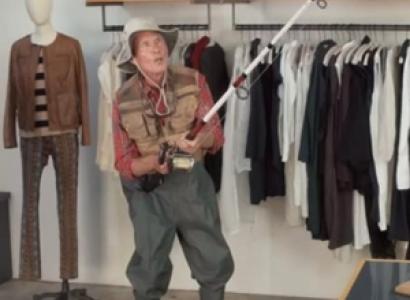 Person in a clothes store with fishing rod