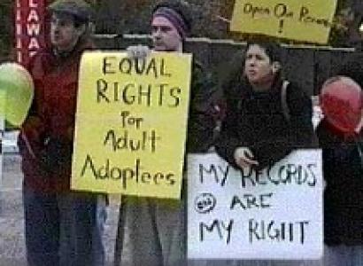 People outside holding protest signs saying Equal Rights for Adult Adoptees