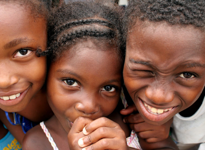 Little black girl with braids with two other black kids