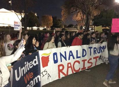 Anti-Trump protest with Trump is racist sign