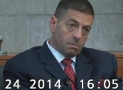 White middle aged man with crew cut and big bags under his eyes wearing a suit looking off to the side with a very worried expression on his face 