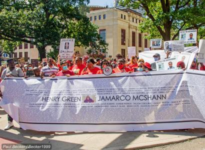 People marching with big banner