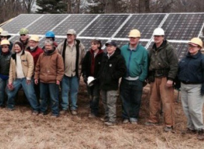 People involved in Clintonville Energy Co-op posing by solar panels