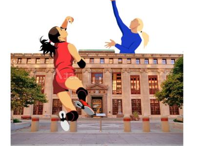 Two women playing volleyball on either side of City Hall