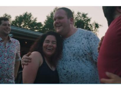 Man hugging woman while both laughing