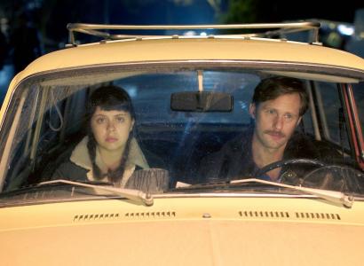 Man and young woman in front seat of car