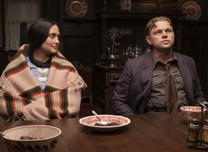 Native woman and white man at a dinner table