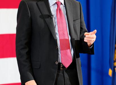 John Kasich in front of flag