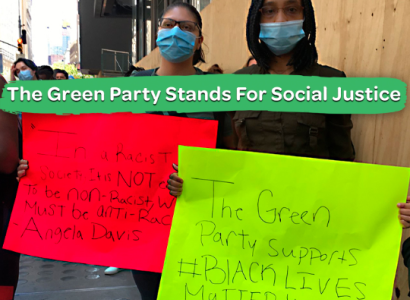 People holding signs and saying Green Party stands for social justice