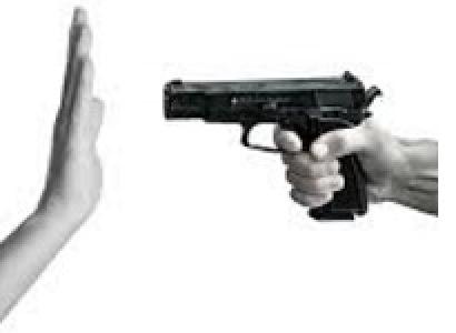 Someone pointing a gun with a side view and someone holding up their hand in front of it