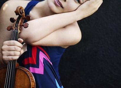 Young woman posing with a violin