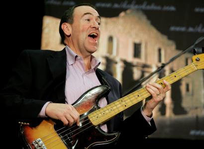 Mike Huckabee playing the bass guitar