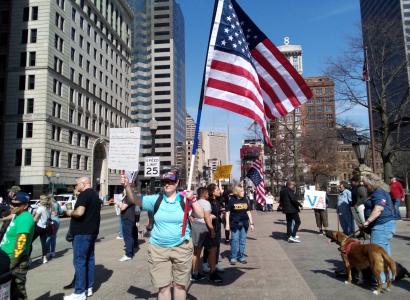 Protesters and one holding US flag