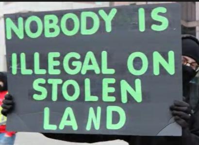 Sign saying nobody is illegal on stolen land
