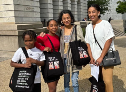 A mother and three kids posing