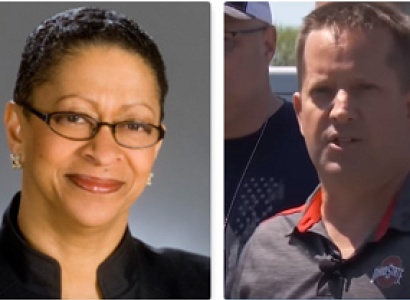 Black woman smiling and white man talking