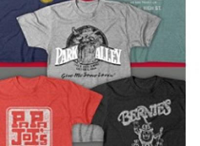 Five T-shirts laying out flat each with a different logo from a campus bar on it