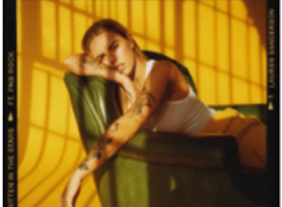 Young white woman lounging backwards in a chair against a yellow background