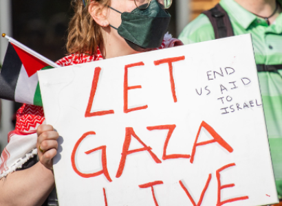 Student holding sign saying Let Gaza Live