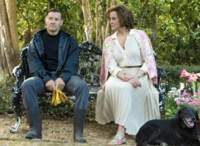 Man and woman sitting outside on a bench