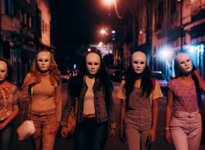 Women walking at night wearing masks