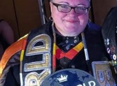 Smiling woman in a crown and sash