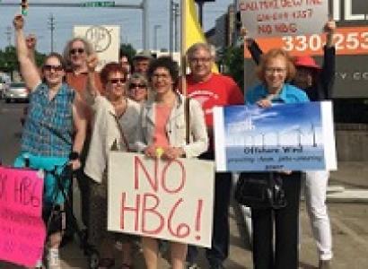 Lots of white people outside with signs against HB6