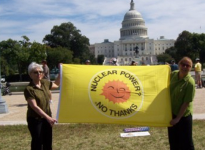 People holding sign saying Nuclear Power No Thanks in front of Congress 