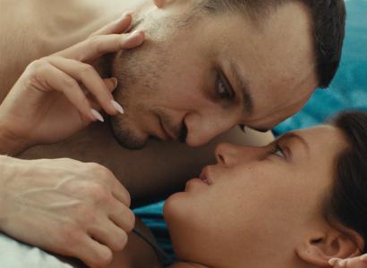 Two people lying face to face