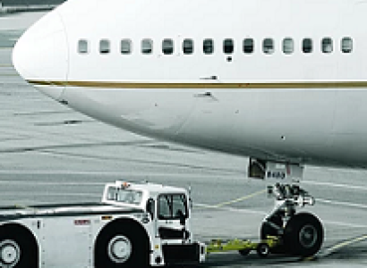 Nose of a jet with a truck next to it