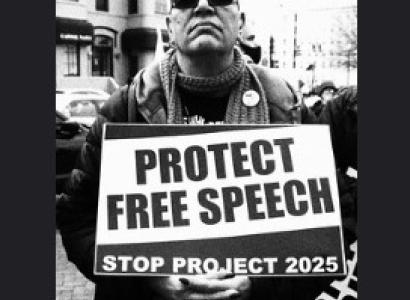  Man holding a sign saying Protect Free Speech Stop Project 2025