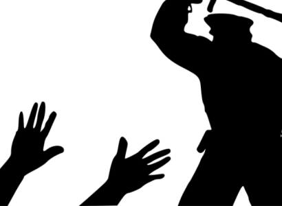 Cop hitting someone on the ground