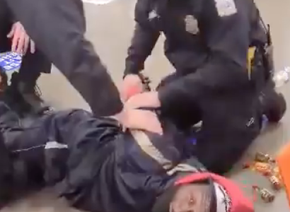 Cops holding a black man down