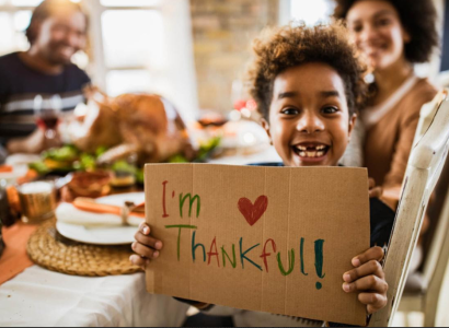 Little boy holding sign I'm Thankful