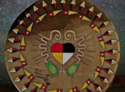 Round mandala with Native American symbols and a heart in the middle between two swiggly  lines depicting the serpent mound