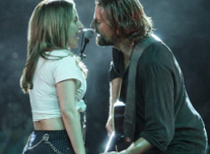 Side view of man and woman singing to each other into a mic, man is playing  guitar