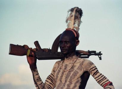 Photos of indigenous man with rifle 