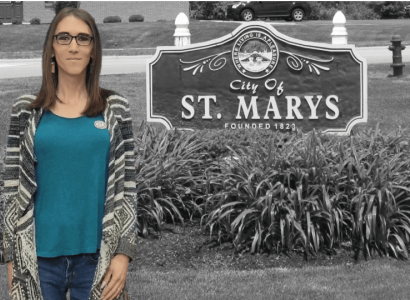 Woman standing next to St. Mary's sign
