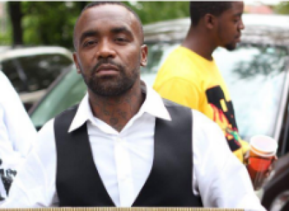 Man holding sign for Tyre