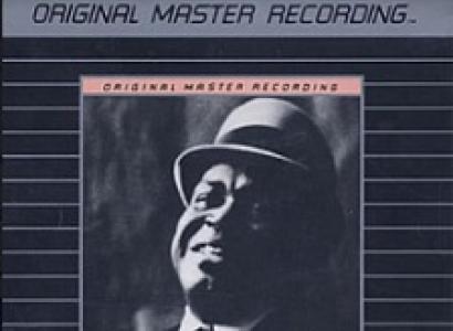 Black album cover with gray thin stripes in the middle there's a black man's face with a bowler hat on at the top it says Original Master Recording then below it says Willie Dixon, I am the Blues