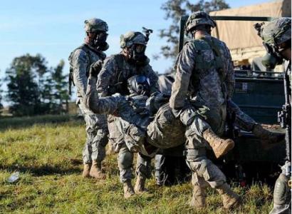 Soldiers carrying wounded man