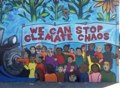 Sign saying we can stop climate chaos with little kids